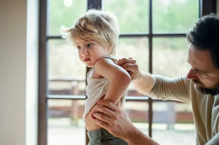 Parent looking at child's eczema on their back