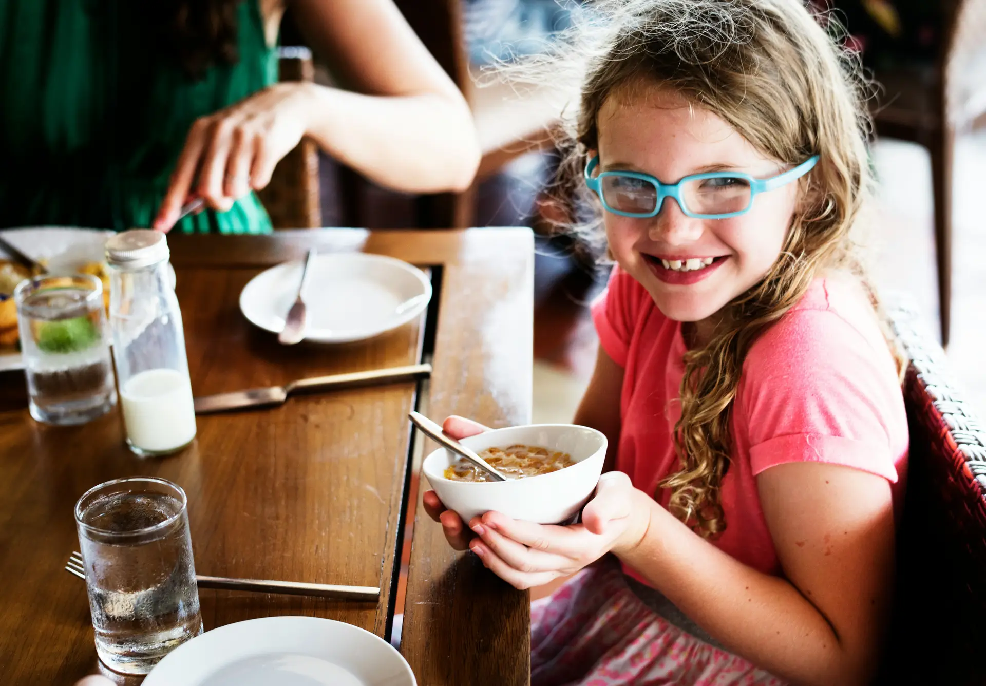 ADHD, ASD girl eating a bowl of beige cereal