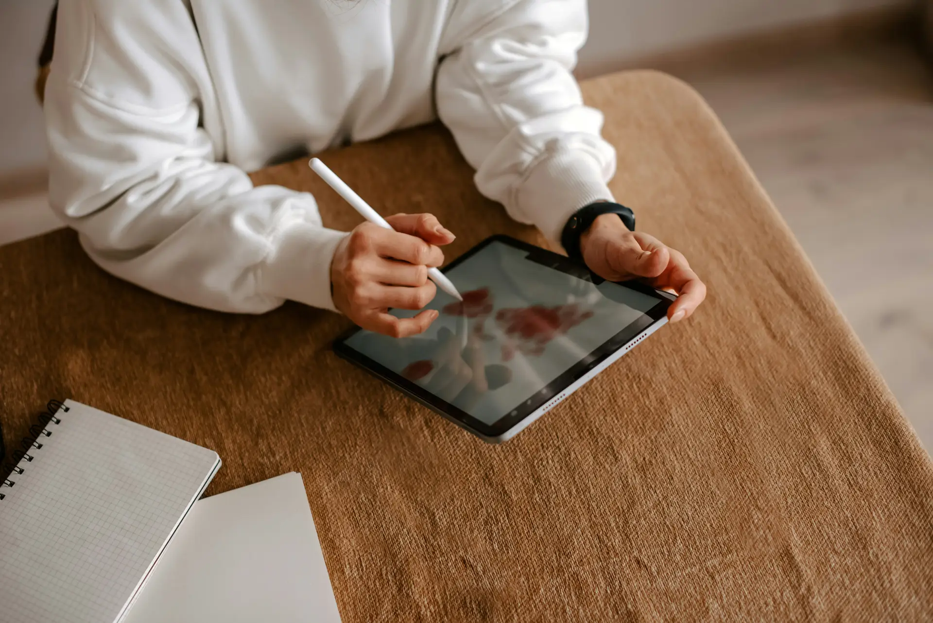 ADHD teen drawing on iPad at the dining table