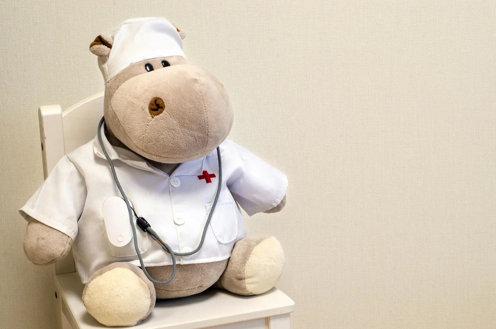 Toy bear dressed as a doctor by sick child